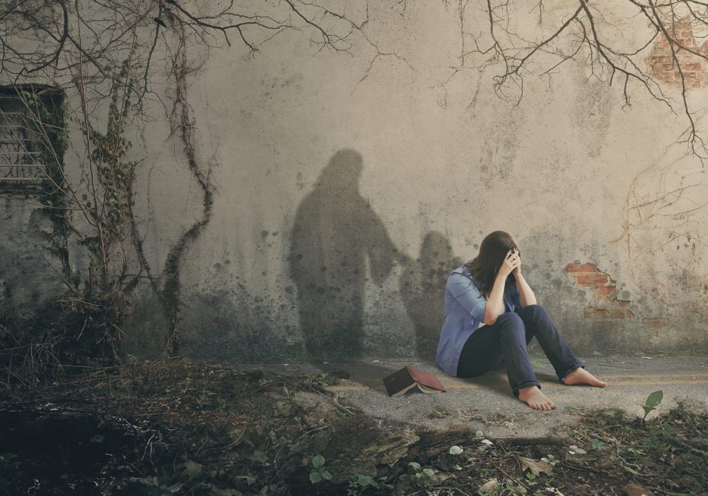 Shadow of Jesus comforts a woman with empathy